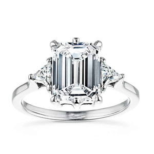 Gorgeous conflict free three stone engagement ring with 2ct emerald cut lab grown diamond center stone with triangle side stones set in 14k white gold band