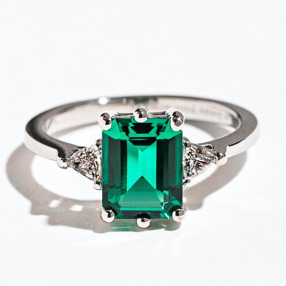 Shown with a 2ct Emerald Cut Lab Created Emerald &amp; Two Triangle Cut Lab Grown Diamonds