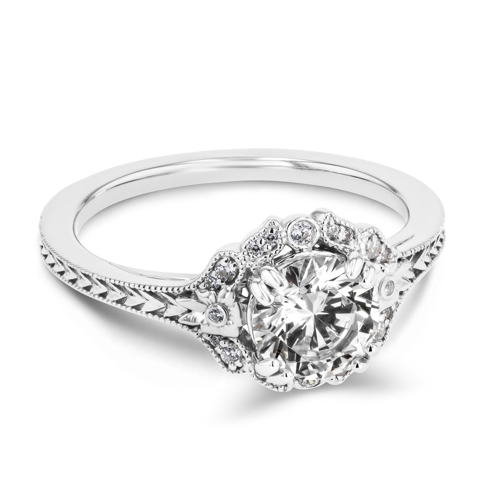 Shown here with a 1.0ct Round Cut Lab Grown Diamond center stone in 14K White Gold|diamond halo engagement ring with chevron detailed band set with a round cut lab grown diamond center stone in 14k white gold recycled metal