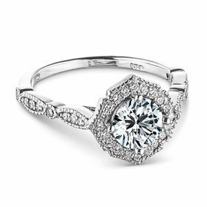 Vintage style engagement ring reminiscent of Paris featuring a diamond accented halo and band with filigree detailing holding a 1ct round cut diamond in 14k white gold