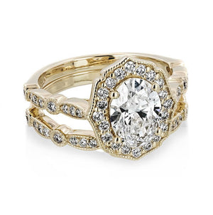  antique vintage stackable wedding set Shown with a 1.0ct Oval cut Lab-Grown Diamond with a diamond accented halo and filigree detailing in recycled 14K yellow gold with matching wedding band