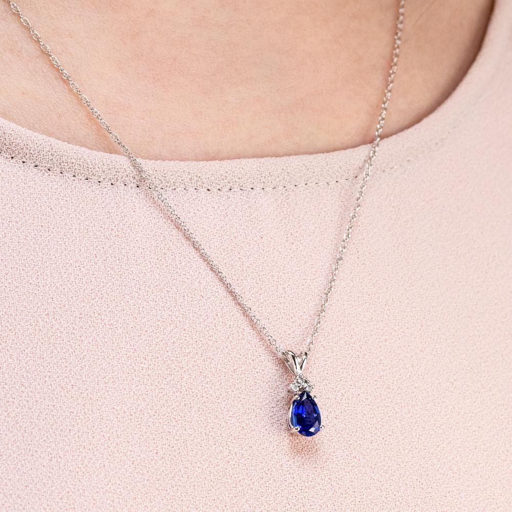 Shown with a 1ct Pear Cut Lab Grown Blue Sapphire in 14k White Gold|Diamond accented tear drop pendant with 1ct pear cut lab created blue sapphire in 14k white gold