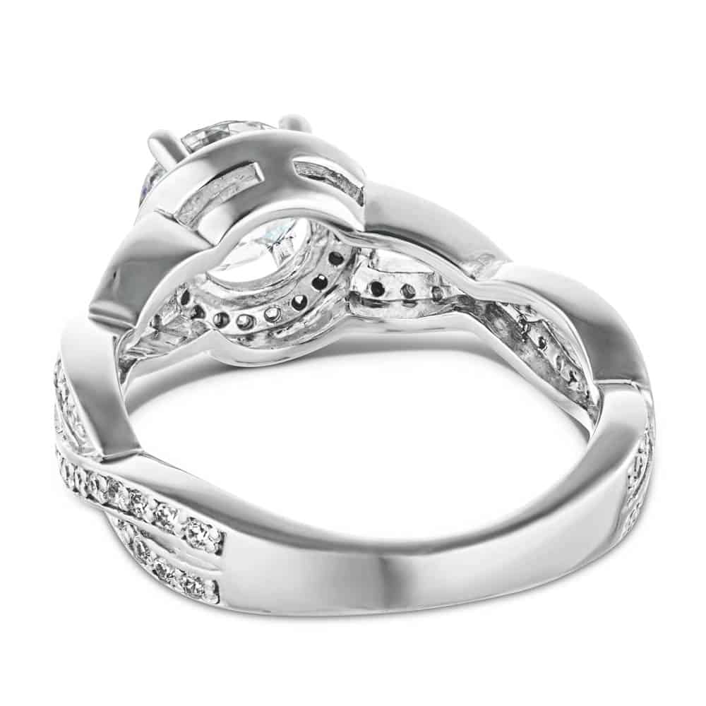 Shown with a 1.0ct Round cut Lab-Grown Diamond with a diamond accented halo and twisted band in recycled 14K white gold 