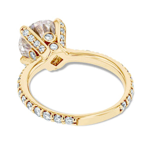 diamond accented vintage style engagement ring with accenting lab grown diamonds and a moissanite center stone with a peeka boo diamond in 14k yellow gold