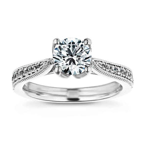 Unique vintage style milgrain and filigree detailed diamond accented engagement ring with a floral head holding a 1ct round cut lab grown diamond in 14k white gold band