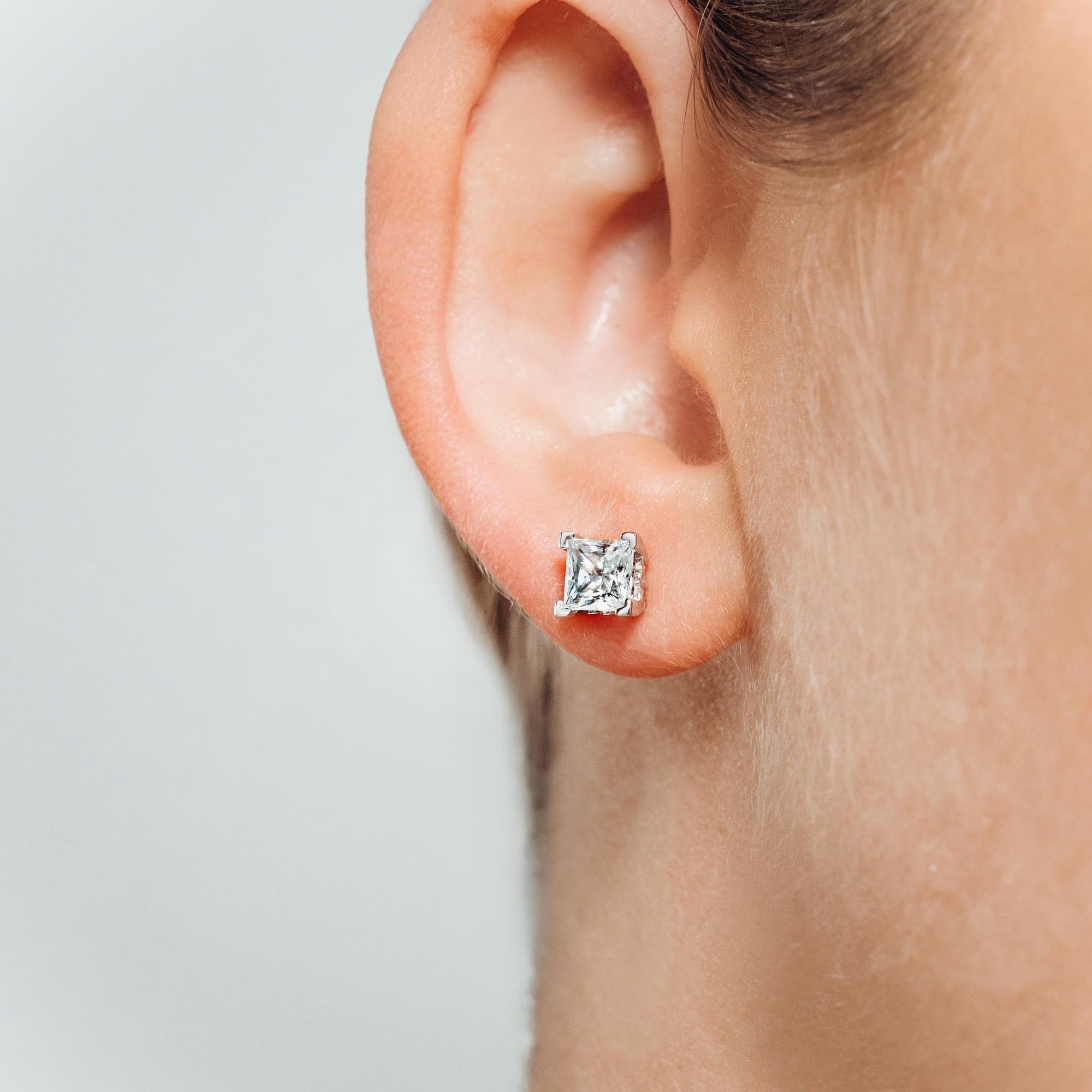 Princess Cut Scroll Stud Earrings in 14K White Gold | princess cut scroll earring studs gold 4 prong