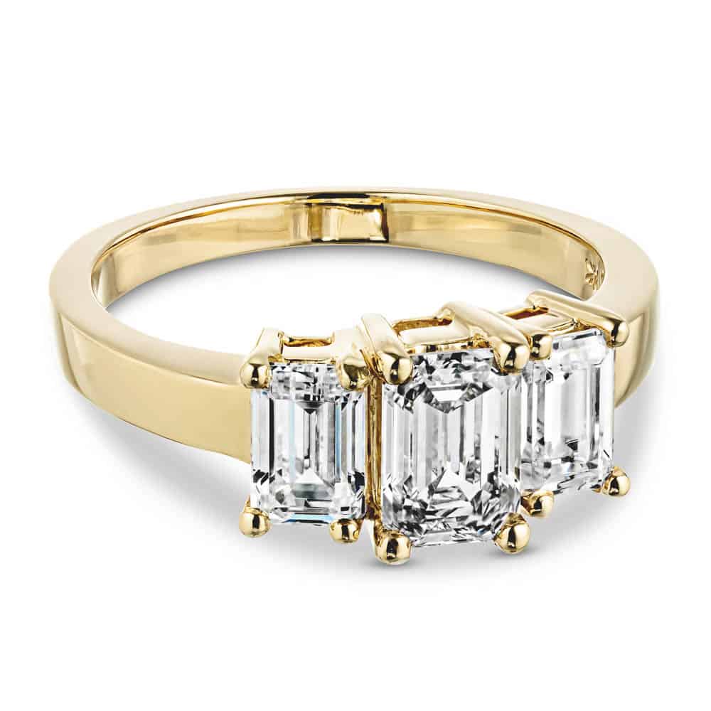 Shown with Emerald Cut Lab Grown Diamonds in 14k Yellow Gold|kim kardashian look-a-like engagement ring with three emerald cut lab grown diamonds in 14k yellow gold band