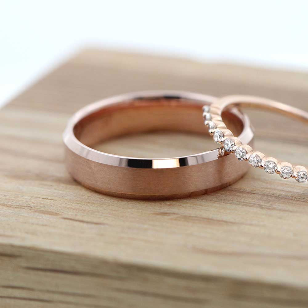 Ridge wedding band in satin finish and recycled 14K rose gold. Picture also featuring our willow diamond band 