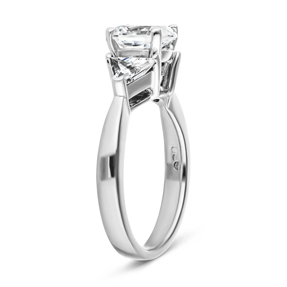 Shown with 1ct Oval Cut Lab Grown Diamond & 0.50ct Triangle Cut Side Stones in 14k White Gold|Unique three stone engagement ring with 1ct oval cut lab grown diamond and two 0.50 triangle cut diamond side stones in 14k white gold setting