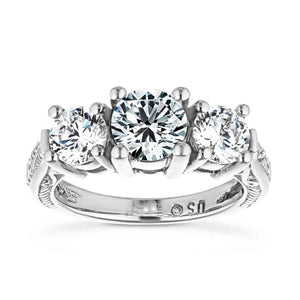 Ethical antique style three stone engagement ring with round cut lab created diamonds in 14k white gold setting with filigree detailing