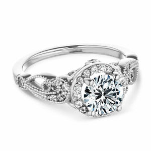 Vintage style diamond accented halo engagement ring with 1ct round cut lab created diamond with milgrain and filigree detailing in two tone 14k white gold