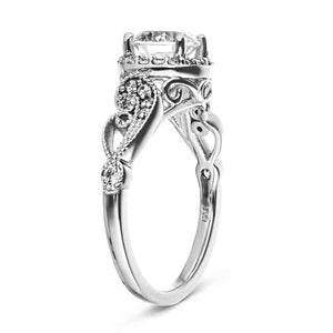 Vintage style diamond accented halo engagement ring with 1ct round cut lab created diamond with milgrain and filigree detailing in two tone 14k white gold shown from side