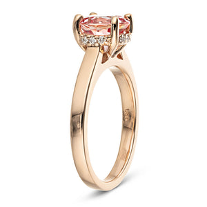 Hidden halo engagement ring with 2ct round cut lab created pink sapphire in 14k rose gold band shown from side