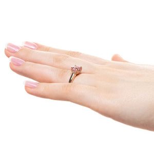 Hidden halo engagement ring with 2ct round cut lab created pink sapphire in 14k rose gold band worn on hand sideview