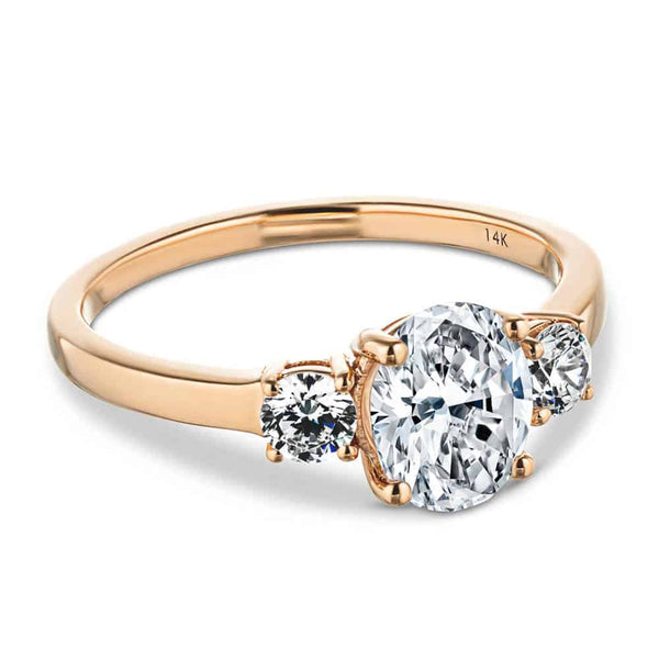 Shown with 1ct Oval Cut Lab Grown Diamond with Two Round Cut Lab Diamonds in 14k Rose Gold|Beautiful unique three stone engagement ring with 1ct oval cut lab grown diamond and two round cut lab diamond shoulder stones in basket style 14k rose gold setting