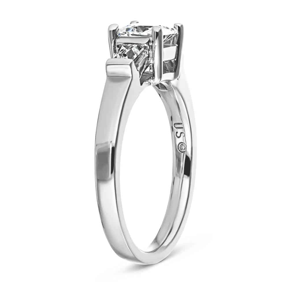 Shown with 1ct Princess Cut Lab Grown Diamond in 14k White Gold|Unique modern three stone engagement ring with 1ct princess cut lab created diamond and two tapered baguette side stones in cathedral style 14k white gold setting
