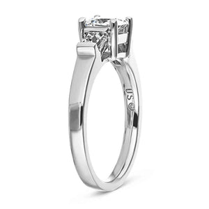 Three stone engagement ring with 1ct princess cut lab created diamond and two tapered baguette side stones in cathedral style 14k white gold setting shown from side
