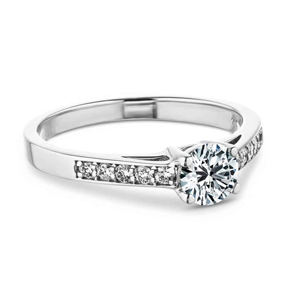 Shown with 0.5ct Round Cut Lab Grown Diamond in 14k White Gold|Unique modern style channel set diamond accented engagement ring with half carat round cut lab grown diamond in 14k white gold setting