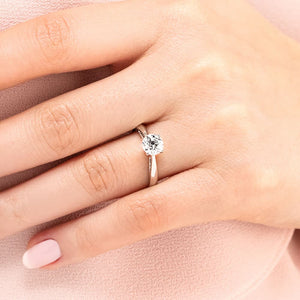 Classic solitaire engagement ring with 1ct round cut lab grown diamond in cathedral style 14k white gold band shown worn on hand