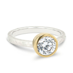 bezel set solitaire engagement ring with satin hammer finish in two tone 14k white gold and yellow gold metal