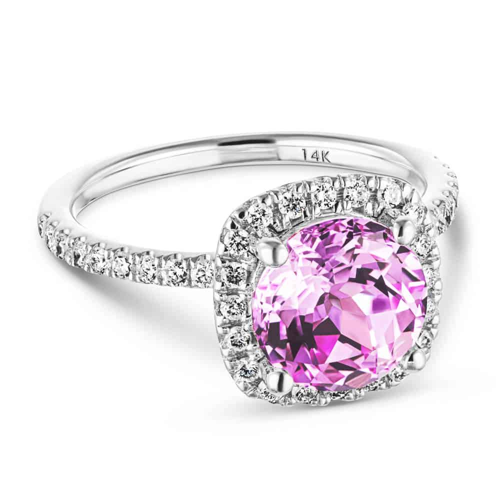 Shown with a 2.75ct Round cut Pink Sapphire Lab Created Gemstone with a diamond accented halo and accented band in recycled 14K white gold 