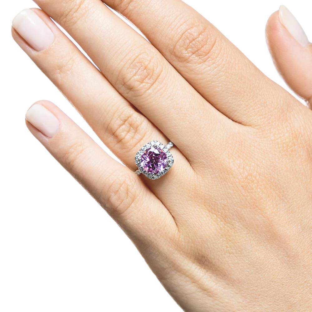 Shown with a 2.75ct Round cut Pink Sapphire Lab Created Gemstone with a diamond accented halo and accented band in recycled 14K white gold 