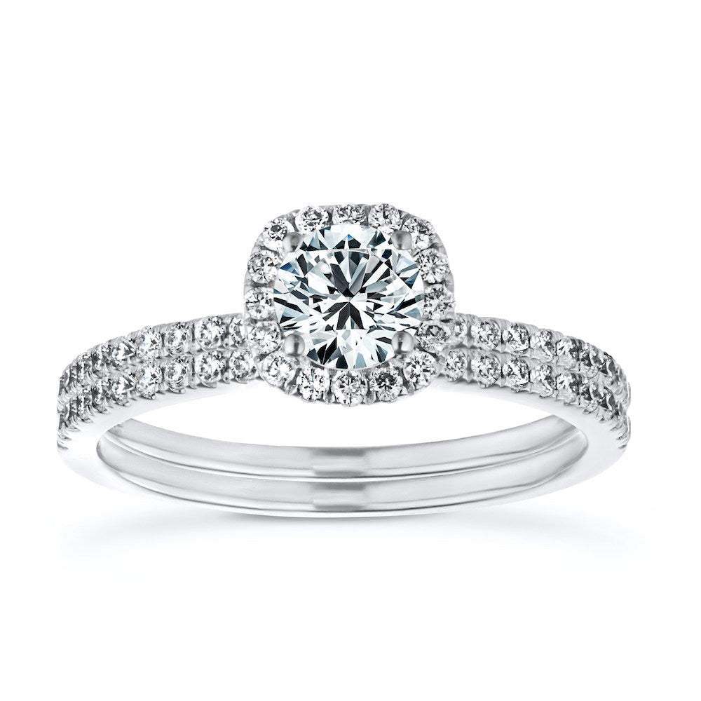 Shown with a 1.0ct Round cut Lab-Grown Diamond with diamond accented halo and band in recycled 14K white gold with matching wedding band, can be purchased together for a discounted price 