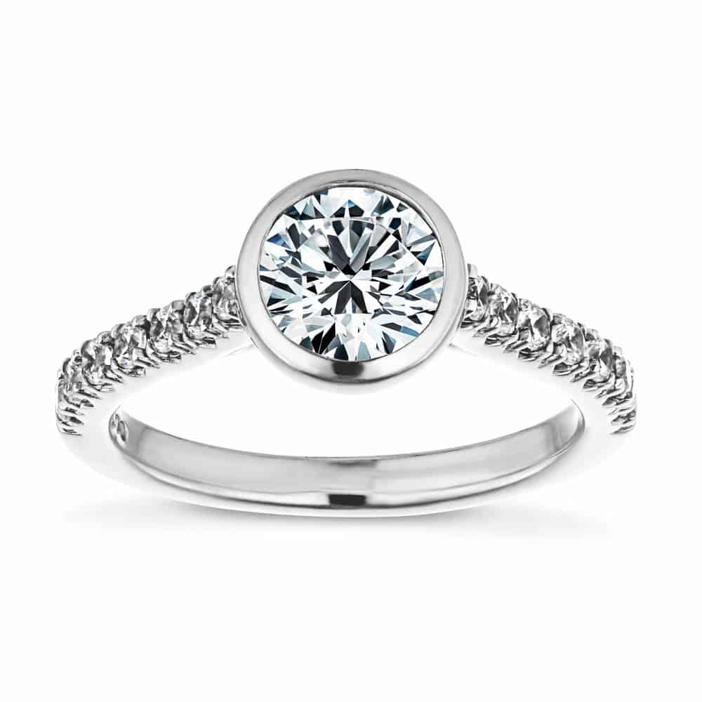 Shown with a bezel set 1.0ct Round cut Lab-Grown Diamond with accenting stones on the band in recycled 14K white gold 