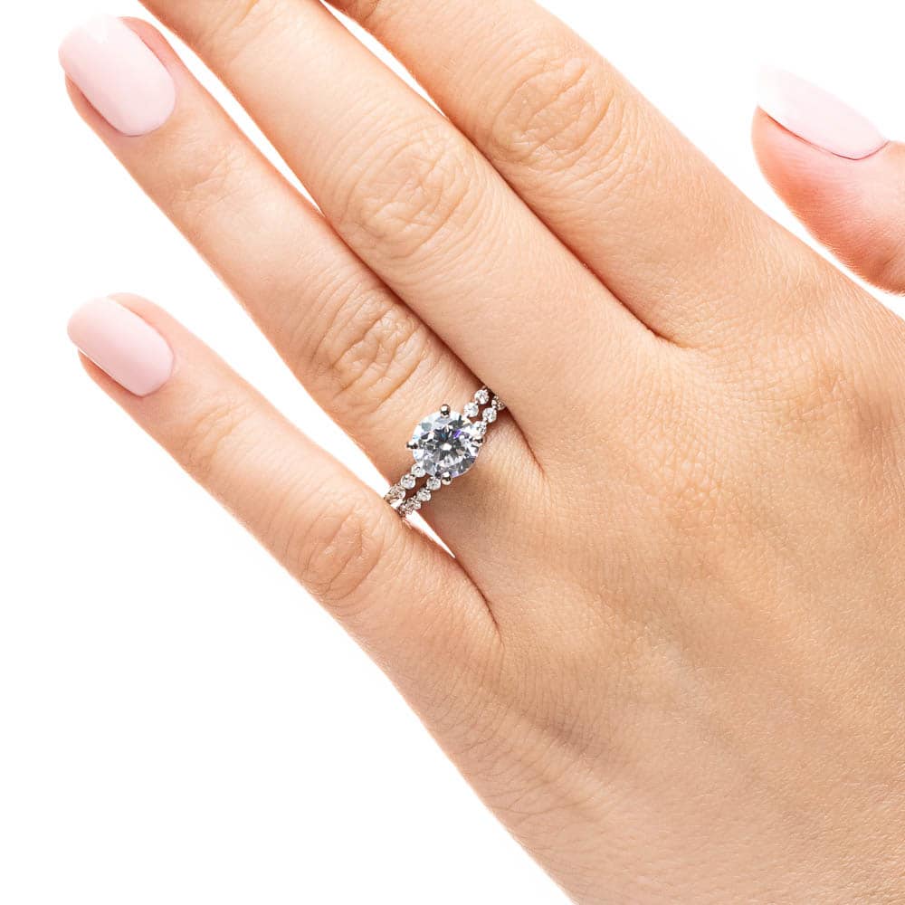 Shown with a 1.0ct Round cut Lab-Grown Diamond with accenting diamonds on the band in recycled 14K white gold with matching wedding band, can be purchased together for a discounted price 