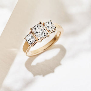 kim kardashian look-a-like engagement ring with three radiant cut lab grown diamonds in 14k yellow gold band